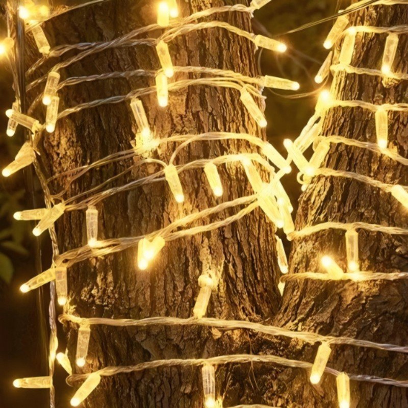 Warm white IP65 LED string lights wrapped around landscape tree trunks