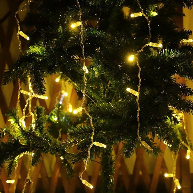 Warm white IP65 LED string lights draped through an artificial tree for hospitality decoration