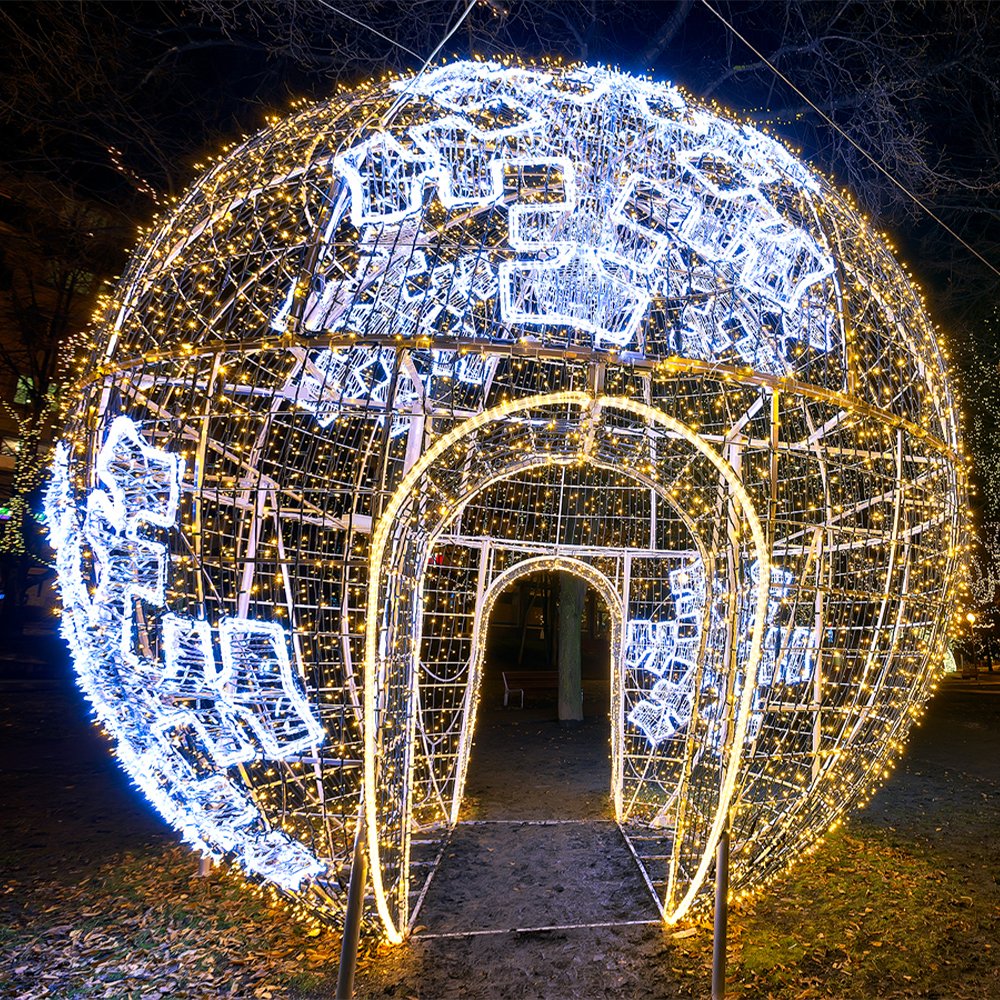 Merry Christmas illuminated bauble pavilion with white snowflake motifs and a walk-through arch