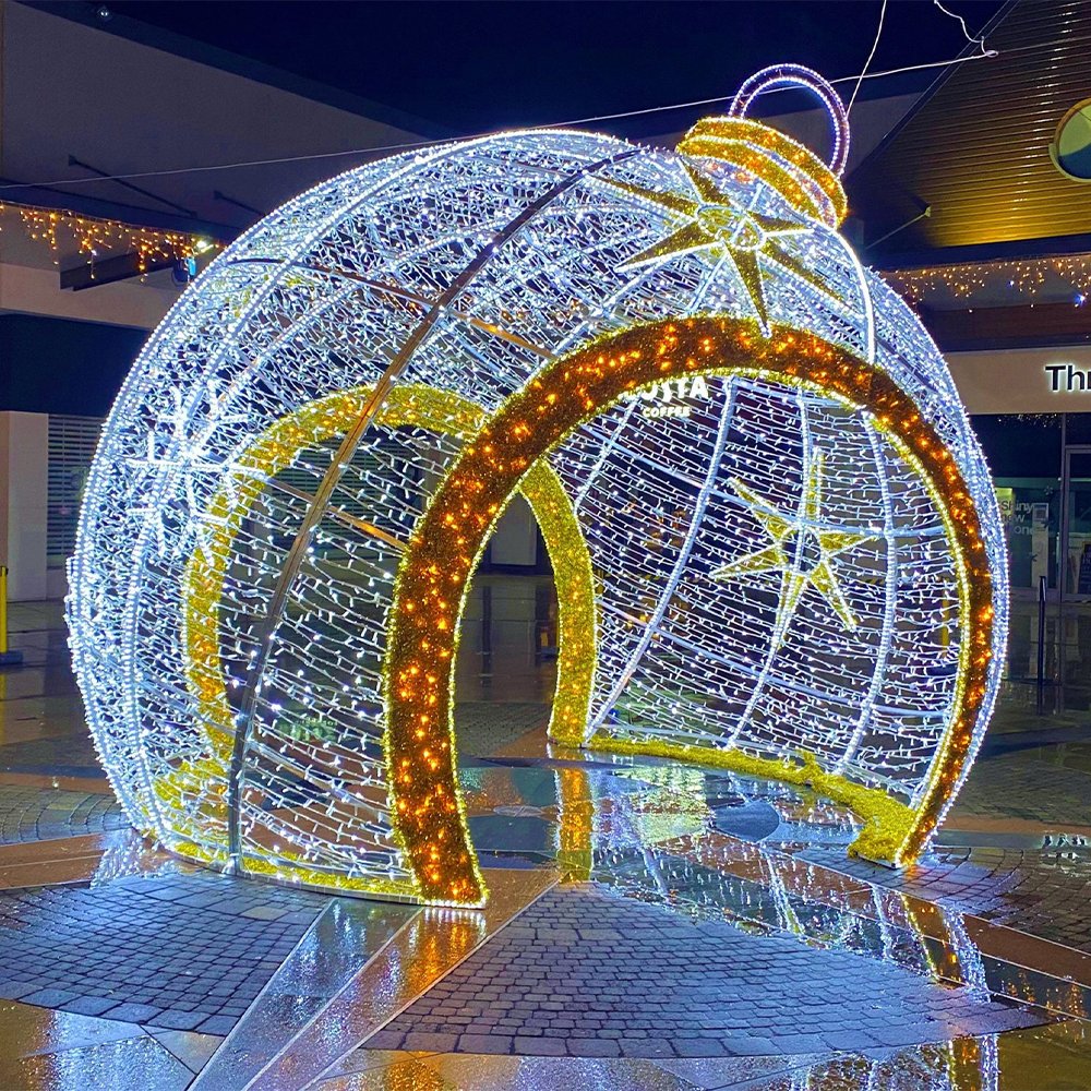 Oversized white holiday sphere with a contrasting warm illuminated arch