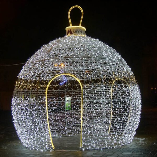White illuminated globe sculpture with an ornament loop and a warm outlined arched opening