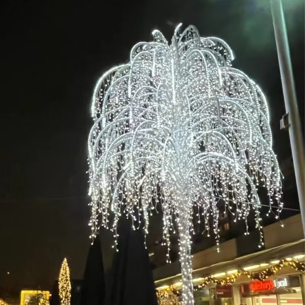 Illuminated willow-style tree with curved branches and cascading white light strands