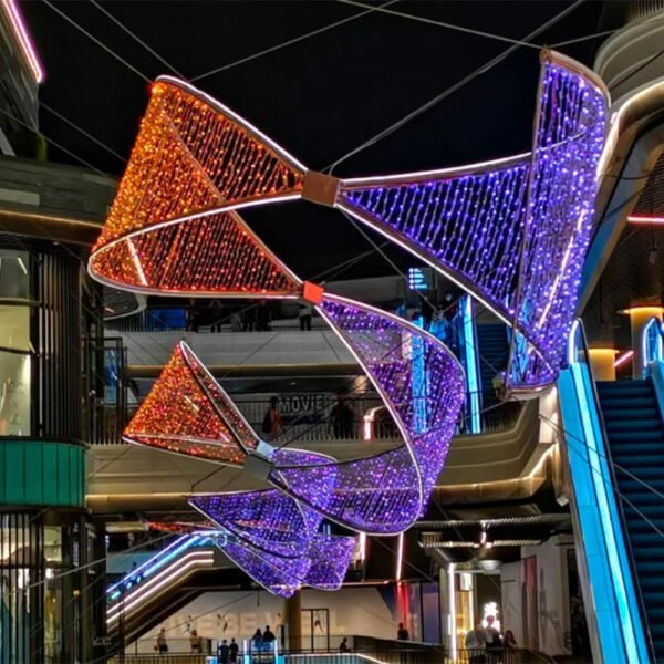 Suspended angular sail-like light panels meeting at central connectors in a multi-level retail atrium