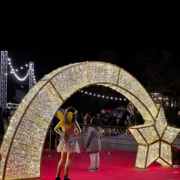 Broad illuminated arch with a large faceted star beside an event reception area
