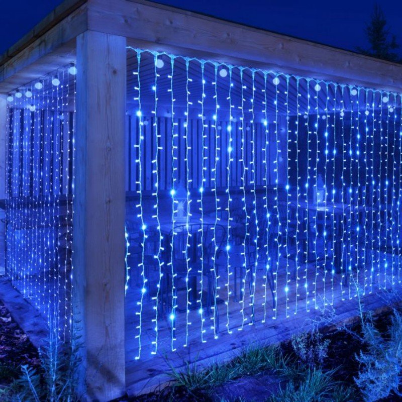Blue curtain lights on two sides of a timber garden shelter around a large corner post