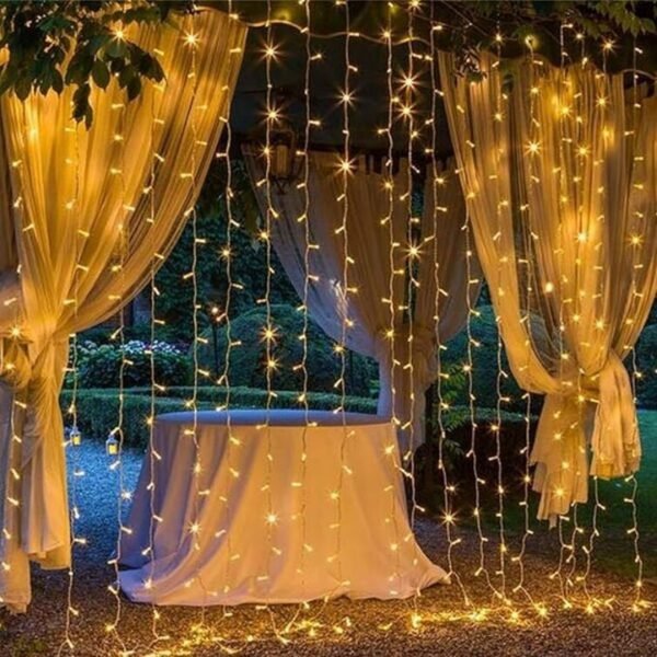 Warm white curtain drops before tied-back garden fabric drapes and a cloth-covered display table