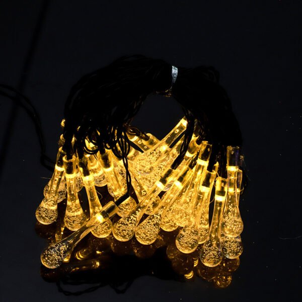 Warm white waterdrop-shaped Edison lights arranged as a bundled product close-up against a dark background