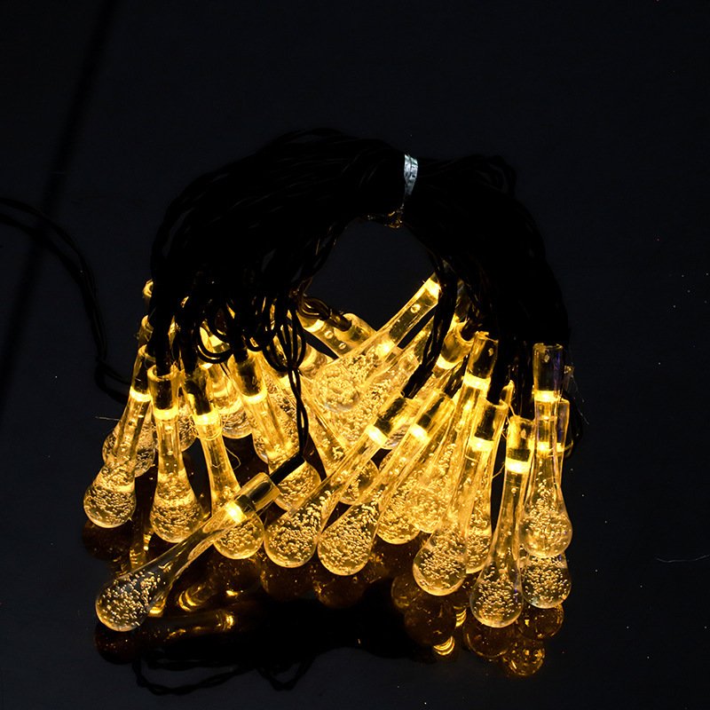 Warm white waterdrop-shaped Edison lights arranged as a bundled product close-up against a dark background