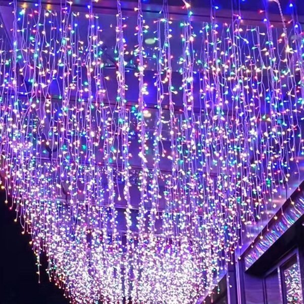 Multicolor icicle lighting displayed along a festival-style corridor