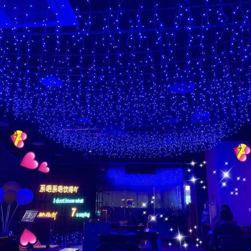 Blue LED icicle lights suspended above an event venue