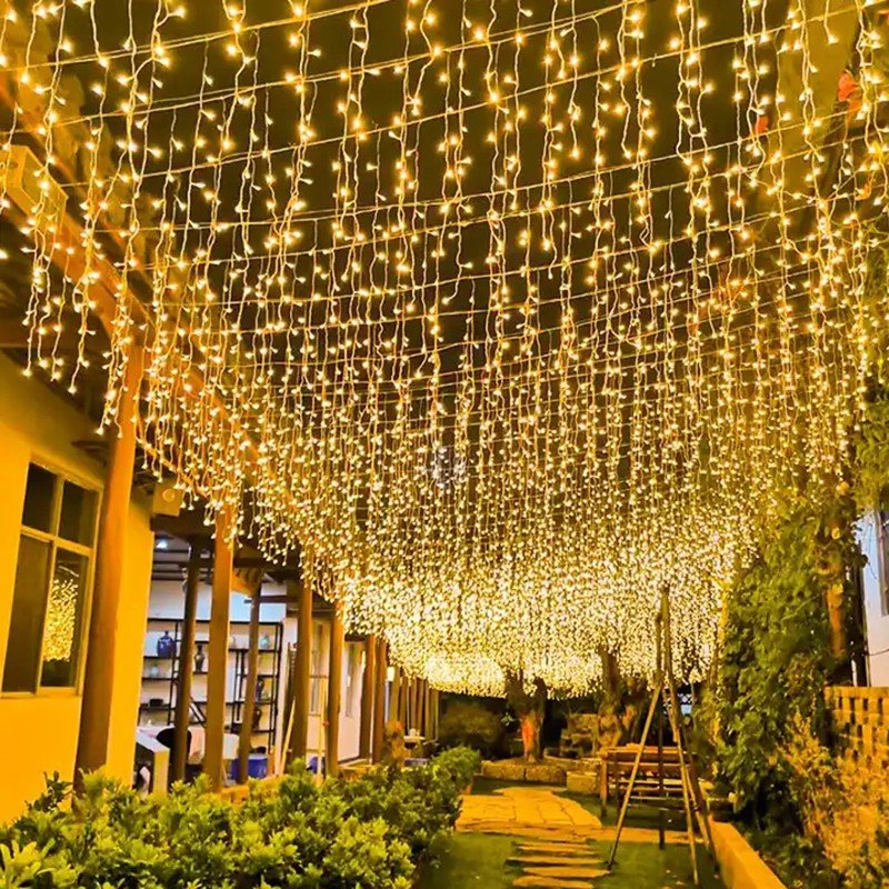 Warm white icicle decoration above a broad pedestrian walkway