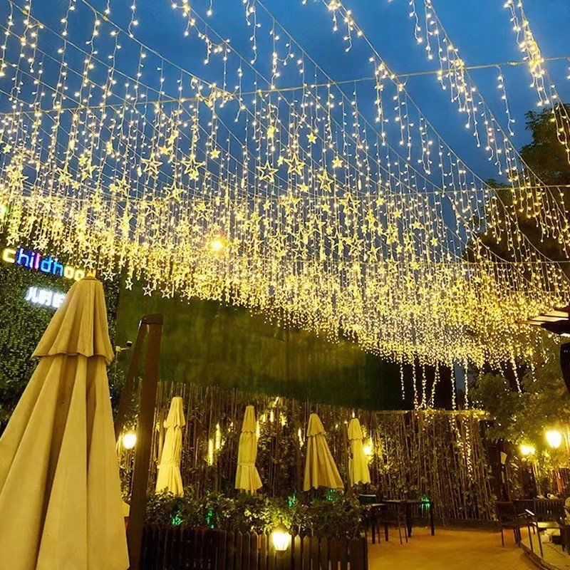 Warm white hanging icicle lights along a pedestrian passage
